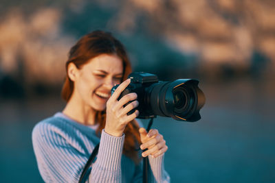 Portrait of woman photographing