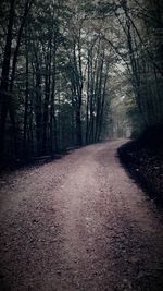 Empty road passing through forest