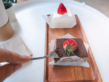 High angle view of person holding ice cream on table