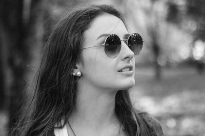 Close-up of beautiful young woman wearing sunglasses