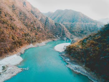 High angle view of sea and mountains against sky