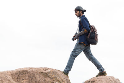 Young man standing on rock