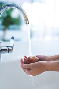 Low section of woman washing hands
