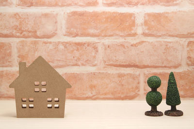 Close-up of toy on brick wall of house