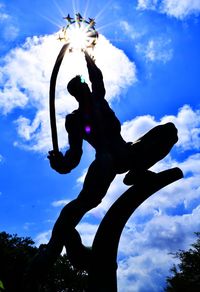 Low angle view of statue against cloudy sky