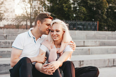 Young couple sitting outdoors