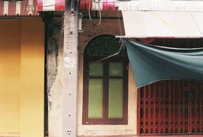 Close-up of clothes hanging on window of building