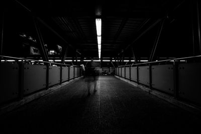 Rear view of person walking at subway station