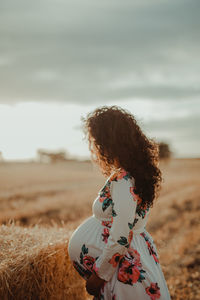 Rear view of woman standing on field