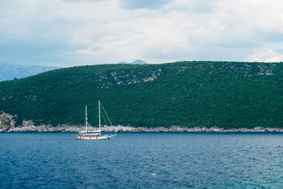 Sailboat sailing on sea against sky