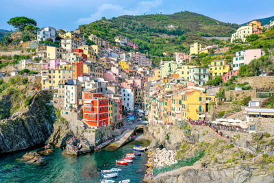 High angle view of townscape by sea against sky