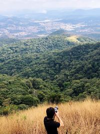 Rear view of woman looking at field