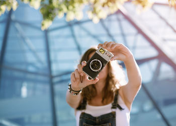 Midsection of woman photographing