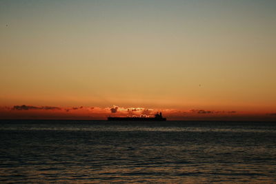 Scenic view of sea against orange sky