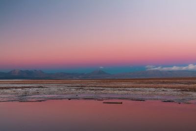 Scenic view of desert against sky during sunset