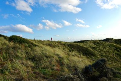 Distant view of woman standing on hill