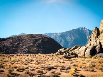 Scenic view of mountains against clear blue sky