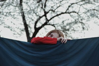 Portrait of woman against red trees