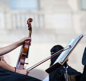 Midsection of man playing violin