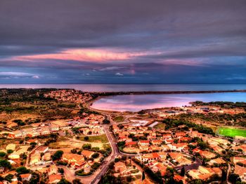 High angle view of buildings by sea against sky