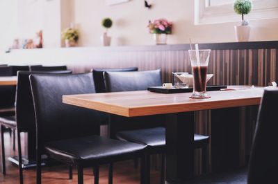 Close-up of chairs and table at home