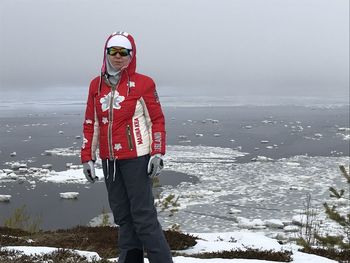 Full length portrait of man standing in snow