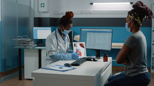 Doctor having discussion with patient in clinic