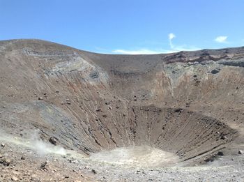 Scenic view of desert against clear blue sky