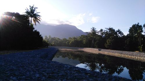 Scenic view of swimming pool by lake against sky