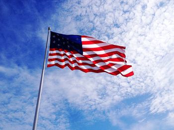 Low angle view of american flag against sky