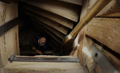 Woman sitting on wooden staircase