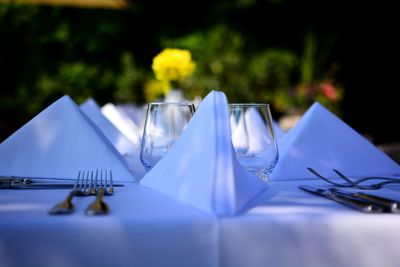 Close-up of napkins and eating utensils on dinning table