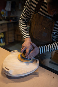 Midsection of man working in workshop