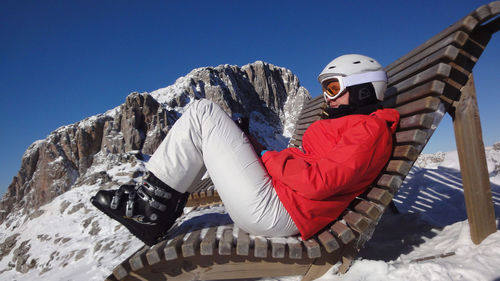 Man on snowcapped mountain against clear sky