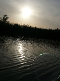 Scenic view of lake at sunset