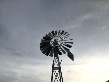 Low angle view of traditional windmill against sky