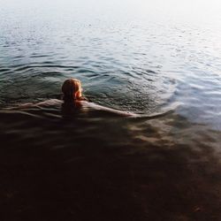 High angle view of woman swimming in lake