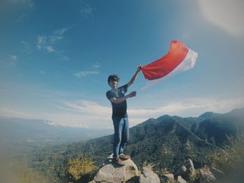Full length of man standing on mountain against sky