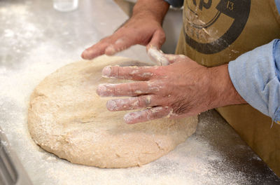 Midsection of man preparing at kitchen