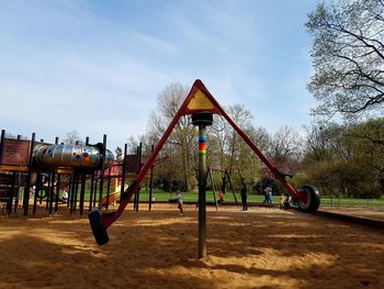 Outdoor play equipment at playground against sky