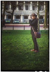 Woman standing on grassy field