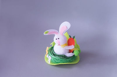 Close-up of colorful easter bunny on purple table