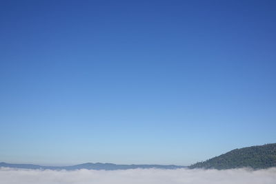 Scenic view of mountains against clear blue sky