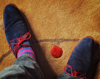 Low section view of man wearing shoe and standing