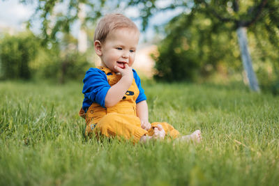 Cute boy playing with toy on land