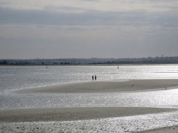 Man on beach against sky