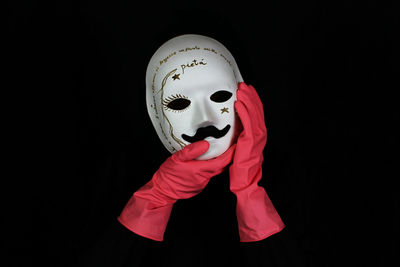 Close-up of mask against black background