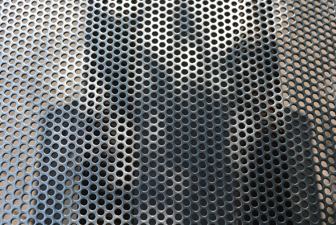 FULL FRAME SHOT OF METAL GRATE ON METALLIC WALL