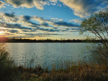 Scenic view of lake against sky during sunset