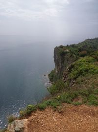 High angle view of sea and mountains against sky